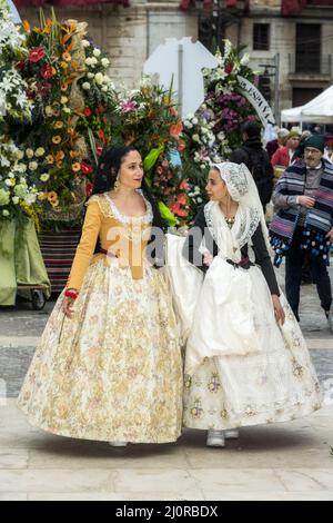 Women falleras marching at the flower offering ceremony (ofrena de flors or ofrenda de flores) during the annual Fallas Festival, Valencia, Spain Stock Photo