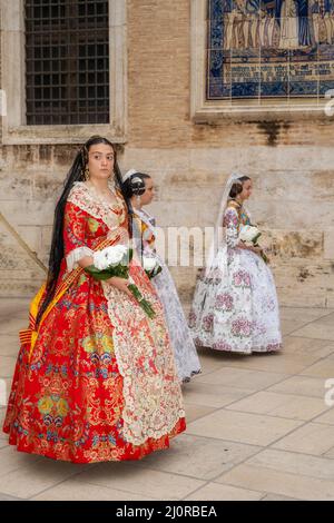 Women falleras marching at the flower offering ceremony (ofrena de flors or ofrenda de flores) during the annual Fallas Festival, Valencia, Spain Stock Photo