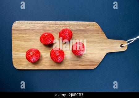 Strawberries on a cutting board. Black background Stock Photo