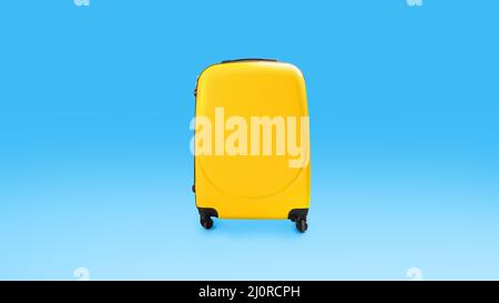 Yellow stylish suitcase isolated over blue studio background wall Stock Photo