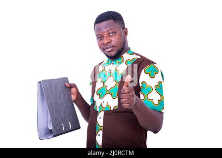 a handsome young businessman in loincloth shirt standing on white background with filing cabinet and making okay gesture. Stock Photo