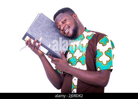 a handsome young businessman in loincloth shirt standing on white background holding a filing cabinet and looking at the camera smiling. Stock Photo