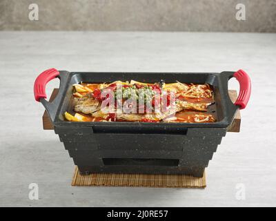 signature fish Golden Snapper in a dish isolated on stew on mat side view on grey background Stock Photo