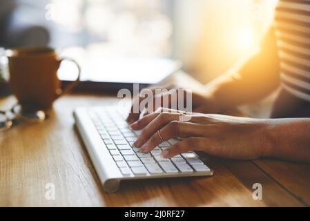Letting her fingers do the talking. Cropped shot of an unrecognizable businesswoman typing on a bluetooth keyboard. Stock Photo