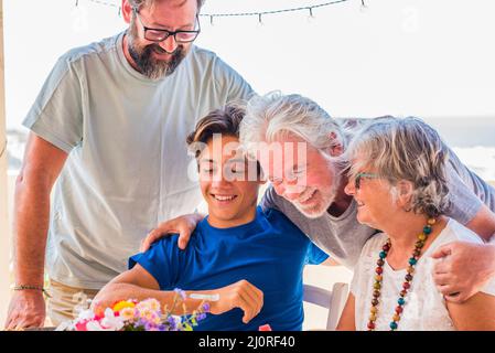Happy mixed ages and generations caucasian family with young adult and senior people together enjoying and having fun. Cheerful grandfathers enjoy par Stock Photo