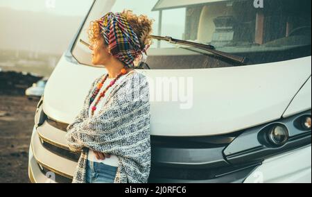 One woman tourist against a modern big camper car motor home alternative house and vehicle for travel and enjoying vacation. Renting van for holiday c Stock Photo