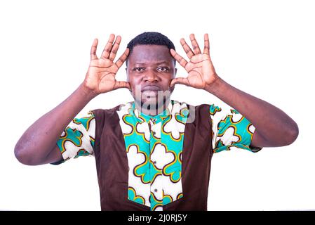 young man wearing loincloth shirt standing on white background making faces. Stock Photo