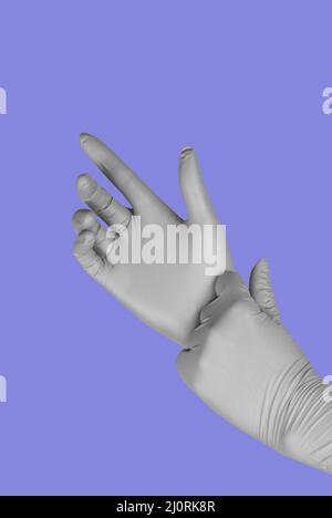 Gray gloves on a colored in trendy violet background Stock Photo