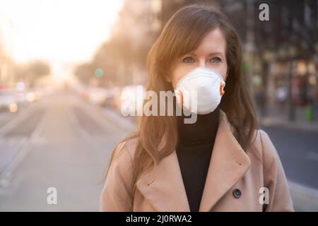 Coronavirus disease - woman wearing face mask in a public to protect herself from the covid-19 virus. Stock Photo