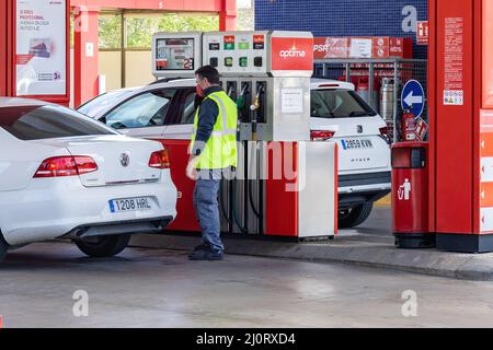 Huelva, Spain - March 6, 2022: View of a petrol pump at a gas station with a car that is refueling Stock Photo