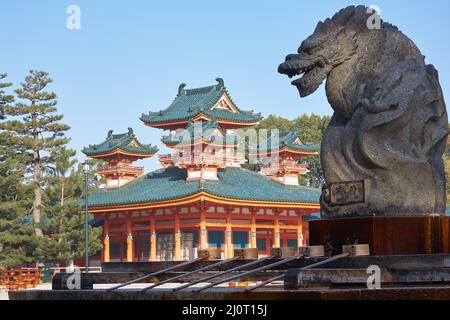 Dragon statue over water ablution basin with Byakko-ro Tower of Heian-jingu Shrine. Kyoto. Japan Stock Photo