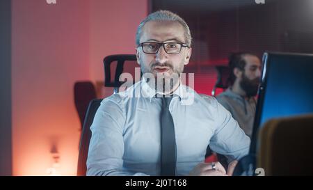 Handsome man in middle aged suit employer is working on a joint project with his young employee Stock Photo