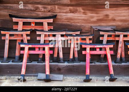 Small wooden torii gate with wishes written on them at Shinto shrine. Kyoto. Japan Stock Photo