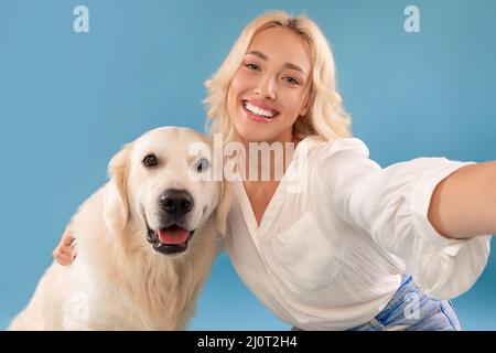 Young woman taking selfie with her happy dog Stock Photo