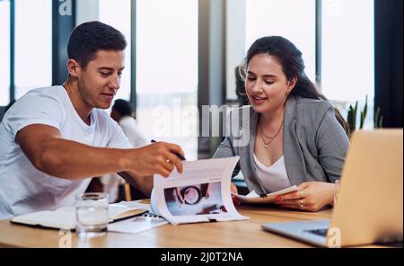 We have so many amazing options to choose from. Shot of two businesspeople going through paperwork together in an office. Stock Photo