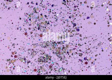 Silver holographic sequins on a pastel purple background. High quality photo Stock Photo