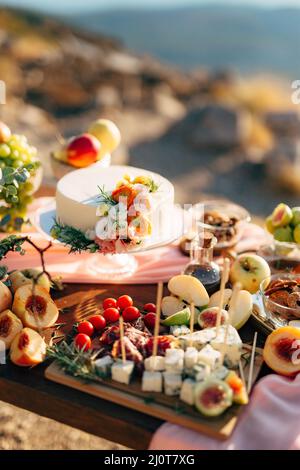 White wedding cake on a set table Stock Photo