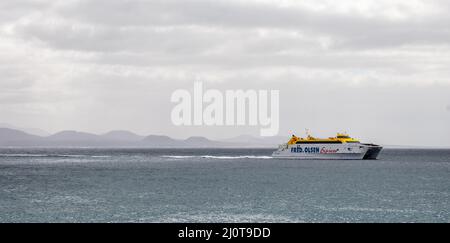 Panoramic view of Fred Olsen Express ferry en route between Lanzarote and Fuerteventura with Fuerteventura in the background in The Canary Islands, Sp