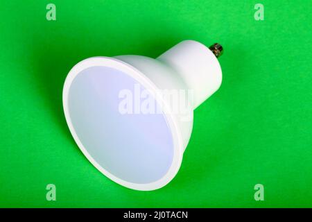 One energy saving GU10 led bulb isolated on a green background Stock Photo