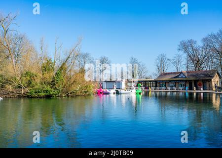 LONDON, UK - MARCH 19, 2022: View of boating lake with Lakeside Café and pedal boats on at Alexandra Palace in London Stock Photo