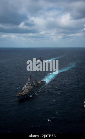 220122-N-PV401-1089 PHILIPPINE SEA (Jan. 22, 2022) Arleigh Burke-class guided-missile destroyer USS Chafee (DDG 90), front, and Ticonderoga-class guided-missile cruiser USS Mobile Bay (CG 53) transit the Philippine Sea, Jan. 22, 2022. Operating as part of U.S. Pacific Fleet, units assigned to Carl Vinson and Abraham Lincoln Carrier Strike Groups, America and Essex Amphibious Ready Groups alongside Japan Maritime Self-Defense Force, are conducting training to preserve and protect a free and open Indo-Pacific region. (U.S. Navy photo by Mass Communication Specialist Seaman Elizabeth Grubbs) Stock Photo