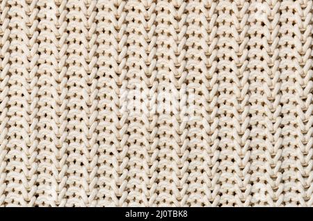 Background of Handmade Knitted fabric of cotton White Cream color, cloth knitted texture. Stock Photo