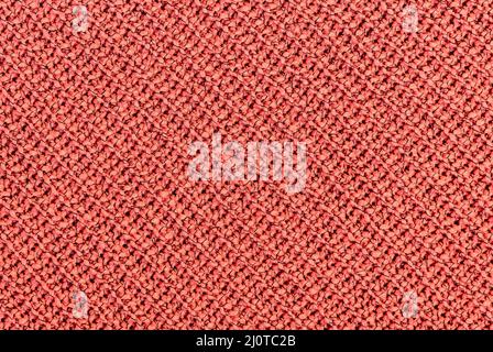 Background of Handmade Knitted fabric of cotton Orange color, cloth knitted texture. Stock Photo