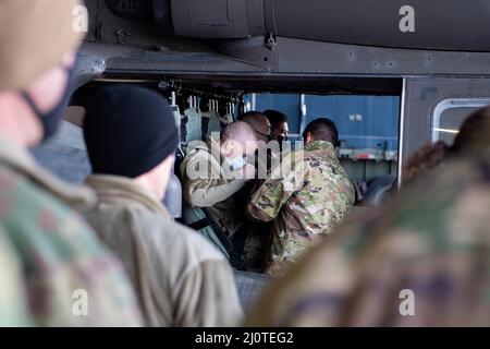 Airmen from across the 39th Air Base Wing learn how to properly buckle into a UH-60 Blackhawk during a mission orientation from the U.S. Army Alpha Company, 3-227th Assault Helicopter Battalion Task Force Werewolves at Incirlik Air Base, Turkey, Jan.. 24, 2022.  Task Force Werewolves ensure the mobility of the joint warfighter in support of U.S. European Command and U.S. Central Command missions throughout Turkey and the wider region. The Werewolves are one of many tenant units that partner with the 39th ABW to promote security and stability in the region. (U.S. Air Force photo by Senior Airma Stock Photo