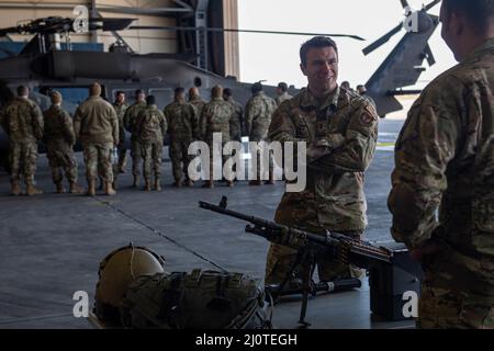 U.S. Air Force 1st Lt. Josef Hartzel, officer in charge of plans and resources assigned to the 39th Communications Squadron, discusses flight equipment with U.S. Army Spc. Thomas Arotzarena, a crew chief assigned to Alpha Company, 3-227th Assault Helicopter Battalion Task Force Werewolves, during a mission orientation at Incirlik Air Base, Turkey, Jan. 24, 2022. Task Force Werewolves ensure the mobility of the joint warfighter in support of U.S. European Command and U.S. Central Command missions throughout Turkey and the wider region. The Werewolves are one of many tenant units that partner wi Stock Photo