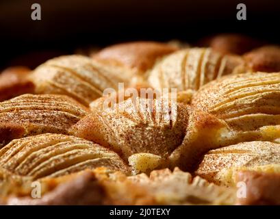 A fully baked apple pie with cinnamon sprinkled over the apples. Stock Photo