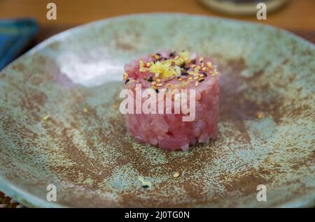 Delicious tuna tartar on a beautifully decorated plate. Stock Photo