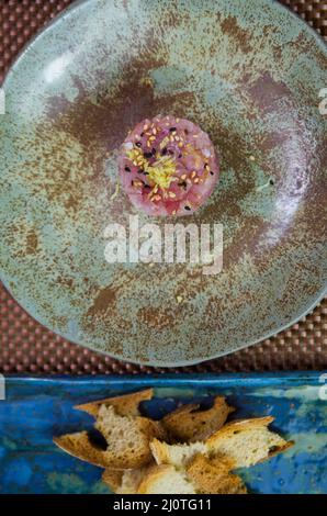 Delicious tuna tartar on a beautifully decorated plate. Stock Photo
