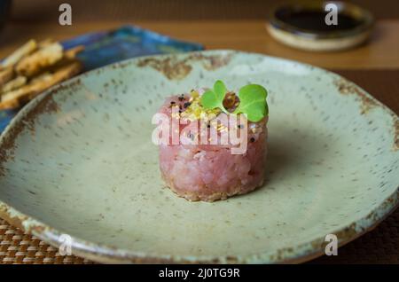 Delicious tuna tartar on a beautifully decorated plate. Stock Photo
