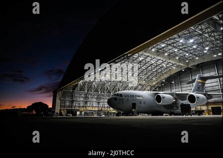 A C-17 Globemaster III sits in Hangar 34 at Joint Base Pearl Habor-Hickam, Hawaii, Jan. 25, 2022. The cargo aircraft is assigned to the 535th Airlift Squadron, which performs over 3,200 flight hours a year to support a free and open Indo-Pacific. (U.S. Air Force photo by Staff Sgt. Alan Ricker) Stock Photo