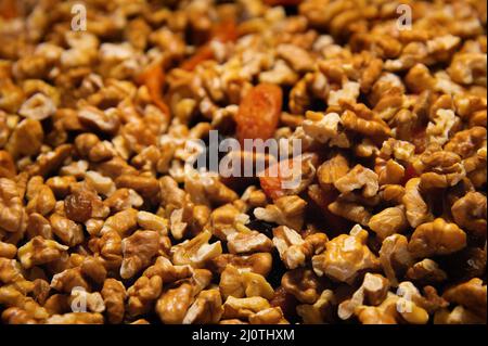 Dried mixture of walnuts and dried fruits close-up. Mix for adding to baked goods. Healthy vegan food Stock Photo