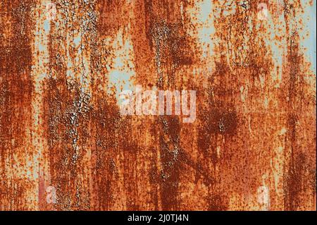 Old metal surface covered with paint through which rust appears. Smudges texture with elements of corrosion Stock Photo