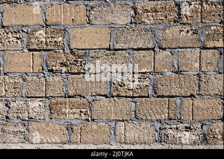Background. Stone wall texture. The shell rock material is bonded with cement mortar Stock Photo