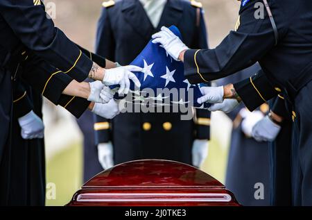 Military Rites U.S. soldiers fold their national flag after a Memorial Day ceremony ...