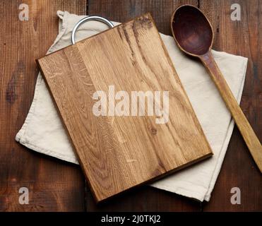 Empty rectangular wooden cutting kitchen board on table, top view, copy space Stock Photo