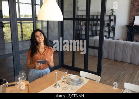 Modern technologies in daily life. Portraif of happy young woman using digital tablet at kitchen, copy space Stock Photo