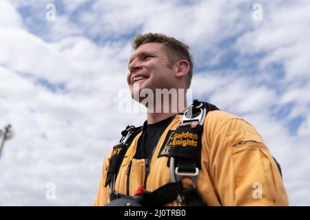 Sgt. 1st Class Danny Hellman of the United States Army parachute team smiles as he gets ready to board the team dash-8 for training jumps at Homestead Air Reserve Base January 27, 2022. (U.S. Army photo by Staff Sgt. Charles Brock) Stock Photo