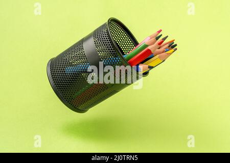 Colored pencils in a black mesh pen pot Stock Photo