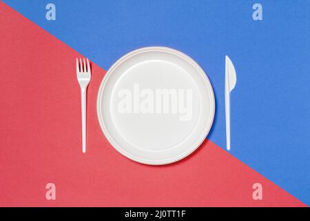 Set of white disposable tableware on colored background Stock Photo