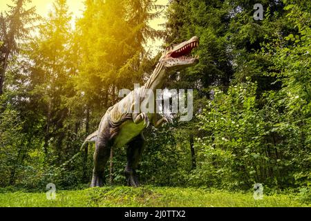 Statue of realistic dinosaur in a woods Stock Photo