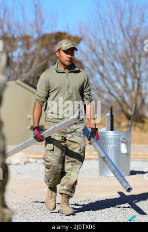 U.S. Air Force Airman 1st Class Edgar Barcenas Zumaya, assigned to Task Force Holloman, helps tear down the Life Support Area on Holloman Air Force Base, New Mexico, Jan. 27, 2022. The Department of Defense, through the U.S. Northern Command, and in support of the Department of Homeland Security, is providing transportation, temporary housing, medical screening, and general support for at least 50,000 Afghan evacuees at suitable facilities, in permanent or temporary structures, as quickly as possible. This initiative provides Afghan personnel essential support at secure locations outside Afgha Stock Photo