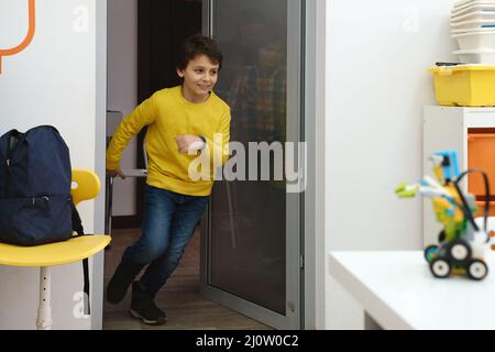 Children pupils running in school room on the brake. Happy kids having fun in elementary school. Modern education  Stock Photo