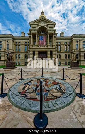 The state seal inlaid in the sidewalk in front of the entrance to the State Capitol in Cheyenne, Wyoming, USA Stock Photo