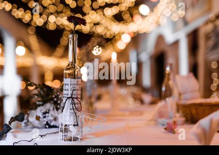 Table setting for wedding party decor flowers lights blurred background Stock Photo