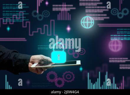 Male hand holds an electronic tablet and a padlock sign on a dark background. Data protection concept, database hacking. Interne Stock Photo