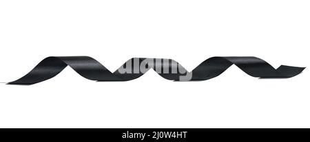 Swirling black silk ribbon on white background, gift wrapping decor Stock Photo